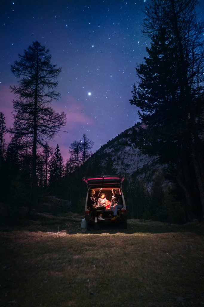 photo of vanlife couple under the stars with free camping