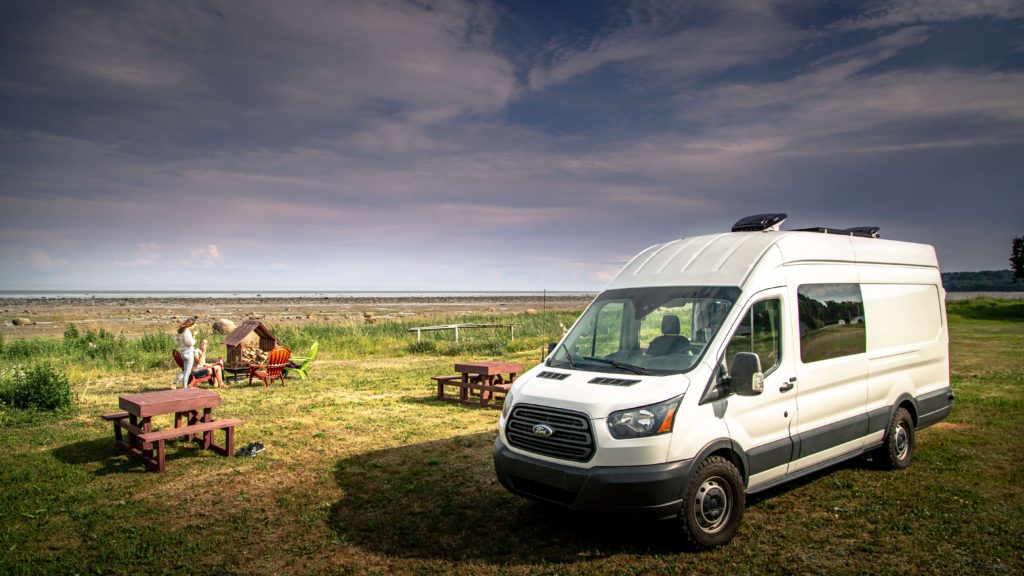 People Having a picnic in front of a Ford Transit Camper Van conversion