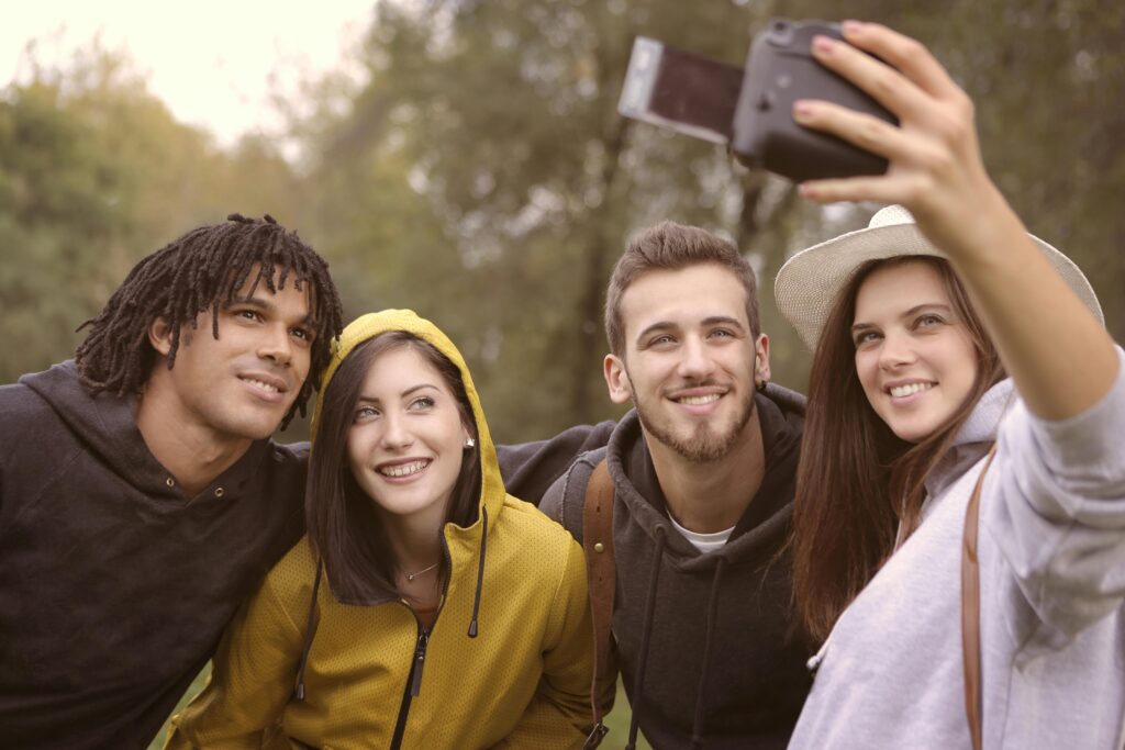 friends taking a photo with digital camera